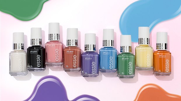 9 bottles of essie jelly gloss nail polish with pools of nail polish in the pink background