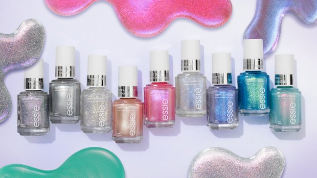 Row of 9 different bottles of essie special effects nail polish against a purple background featuring color swatches.