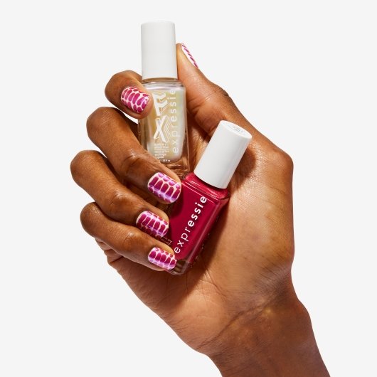 medium skin hand with butterfly print nail art holding pink and frost nail polish bottles