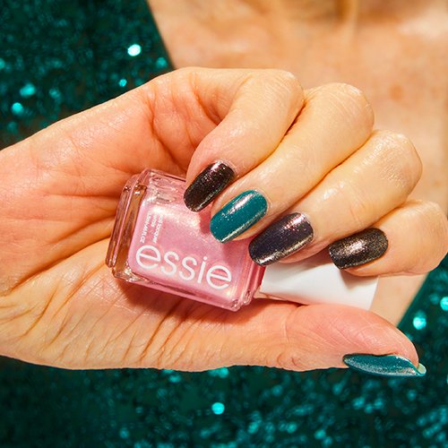 hand with gemstone sparkle multimani nail art holding birthday girl essie nail polish