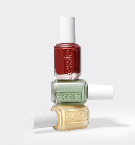 A stack of three essie nail polish bottles in shades Berry Naughty, Crunch Crunch, and Unsalted against a white background.