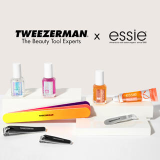 essie nail care polish bottles and roller on a pedestal with Tweezerman nail files, nail clippers, and hangnail cuticle nipper on a white background