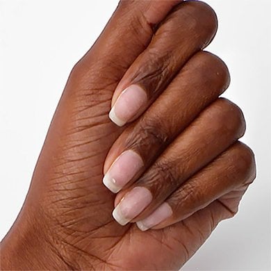 dark skin hard with fingers folded over showing long nails clean stripped of polish