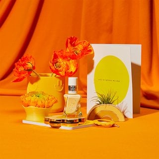 essie lemon nail polish with orange and yellow flowers and bright yellow decorations