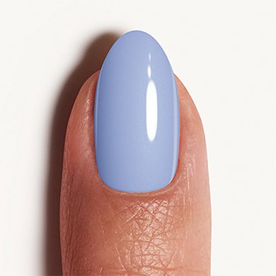 Light skin fingertip with nail painted in cornflower blue 'bikini so teeny' essie polish