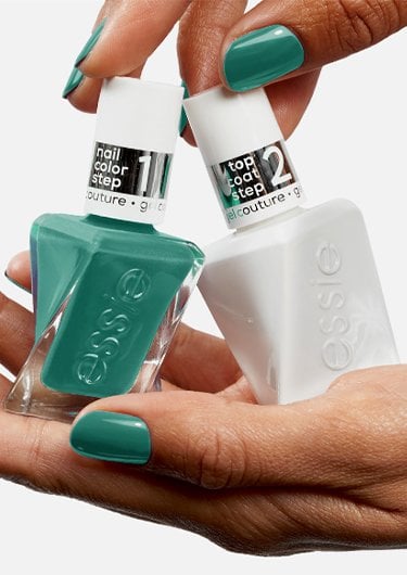 Light skin hands holding 2 bottles of the gel nails system: gel by essie nail polish and gel top coat.
