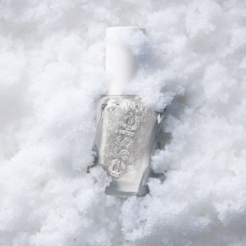 A bottle of silver nail polish partially buried in fluffy white snow, conveying a cool, wintery feel. The bottle has a shiny, metallic finish.