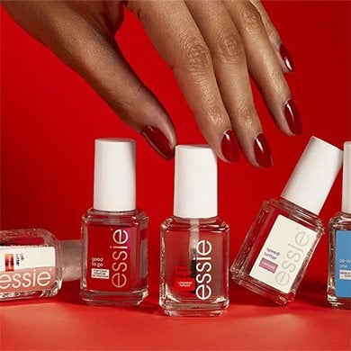Three different essie nail treatments sitting on square glass pedestals on a white surface