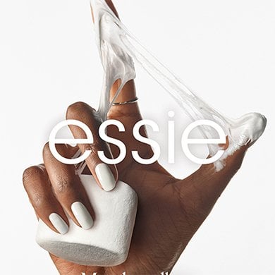 dark skin hand on white background holding a marshmallow with goo between index finger and thumb