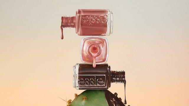Three open bottles of essie boho rodeo nail polish piled on top of a cactus and dripping polish