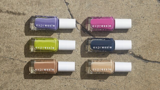 Power moves nail polish collection of 6 bottles lined up in 2 rows of 3 laying on a concrete slab