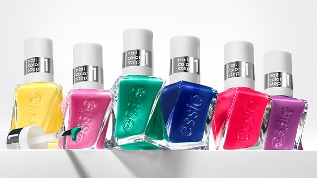 lineup of essie nail polish bottles in shades from the dopamine rush collection on a ledge