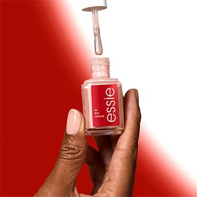 hand holding an open bottle of essie nail hardener on a red and white gradient background