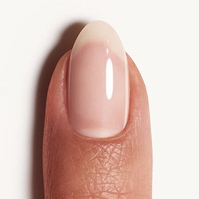 white background with light skin fingernail wearing sheer white glaze nail polish Arctic Jelly