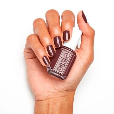hand holding essie not to-do nail polish on a white background