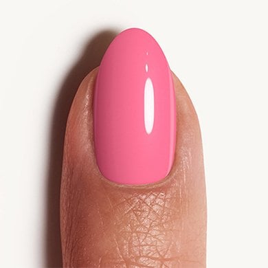 Closeup of a light skin fingertip painted in light pink nail polish Muchi Muchi