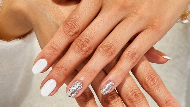 hands displaying diamond multi-mani white nail art design