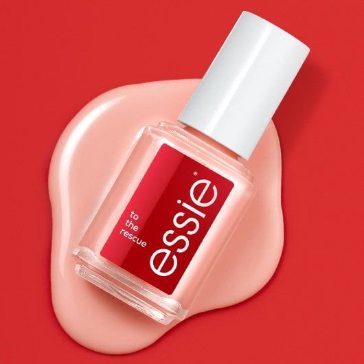 a bottle of essie brittle nails treatment on wet sheer polish with a solid red background. 