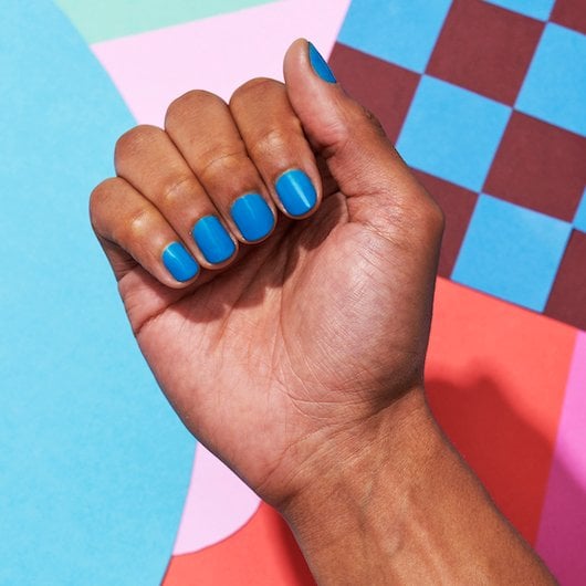 dark skin hand wearing offbeat chic blue nail polish